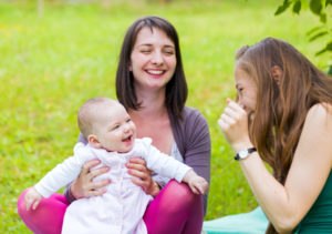 Happy mother and daughter with her babysitter